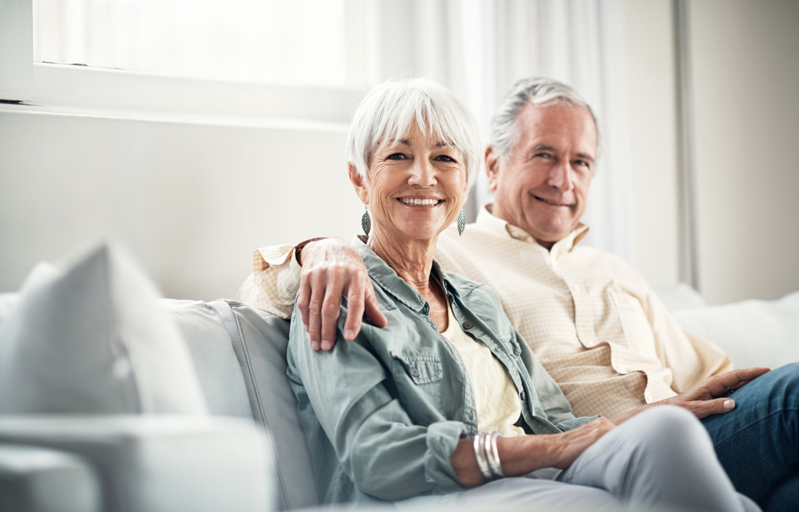 senior couple at home thinking about next bus trip