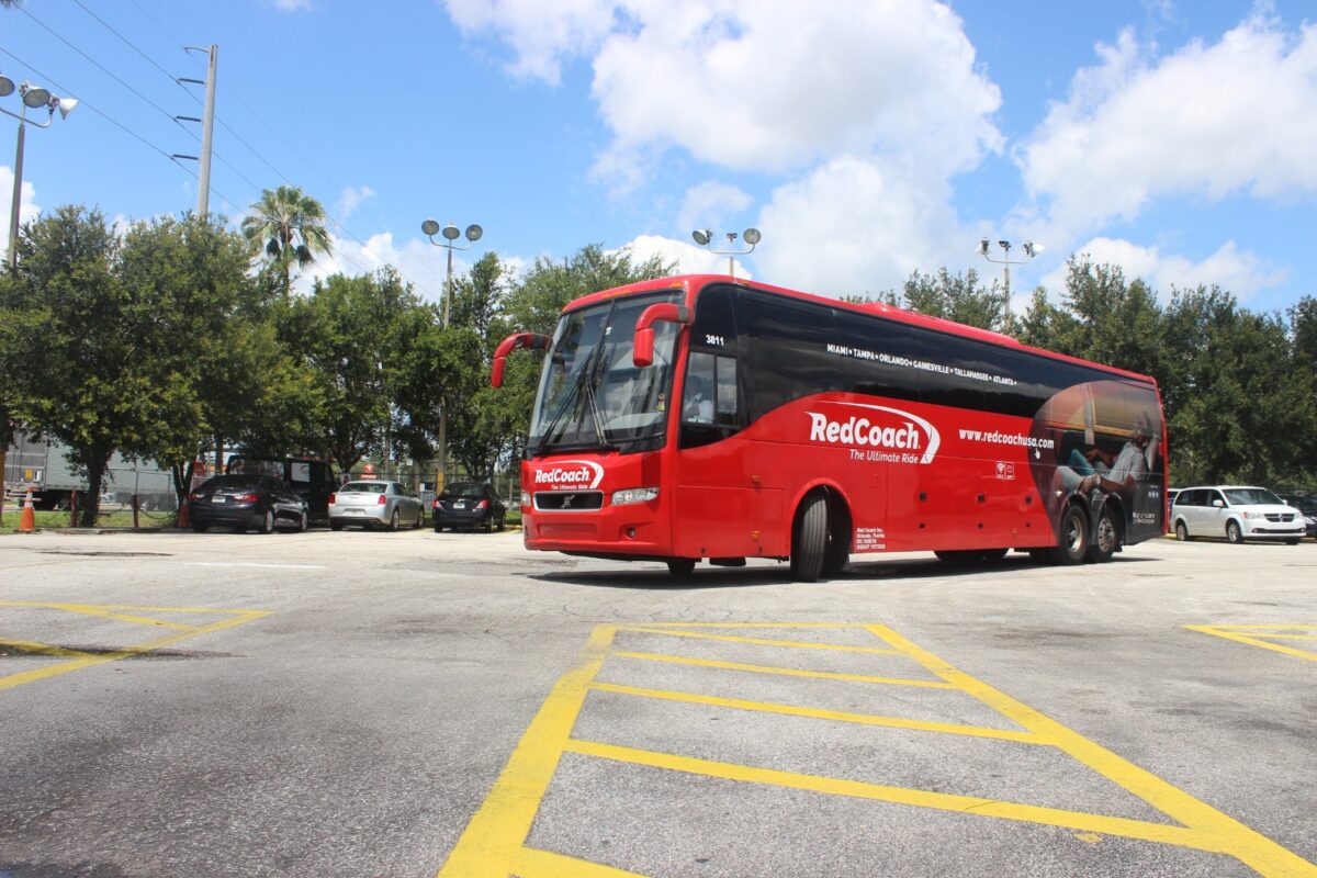 Redcoach bus in parking lot station. Bus trips with RedCoach USA